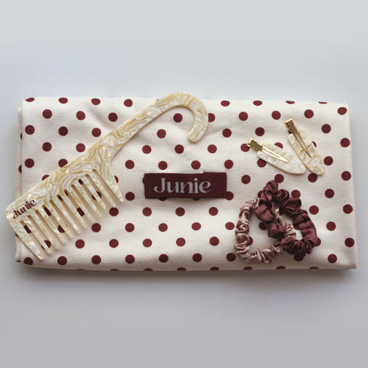 Junie bundle including hair towel, scrunchies, crease-free clips, and wide-tooth comb, arranged neatly for gifting or self-care