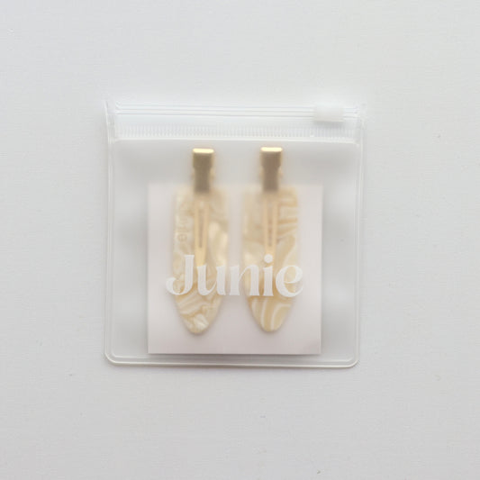Junie crease-free hair clips in ivory with gold accents, neatly packaged in a reusable zip lock bag with Junie branding for gifting or storage