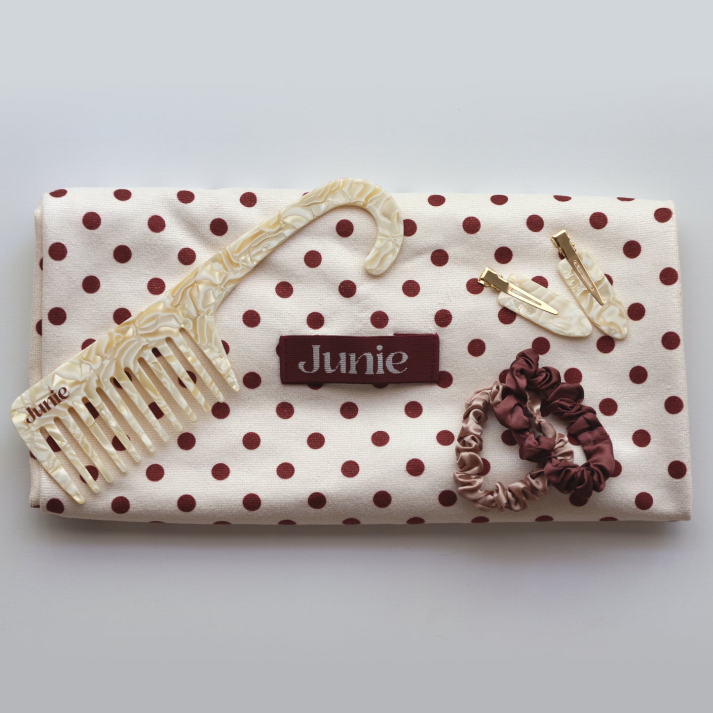 Junie bundle including hair towel, scrunchies, crease-free clips, and wide-tooth comb, arranged neatly for gifting or self-care