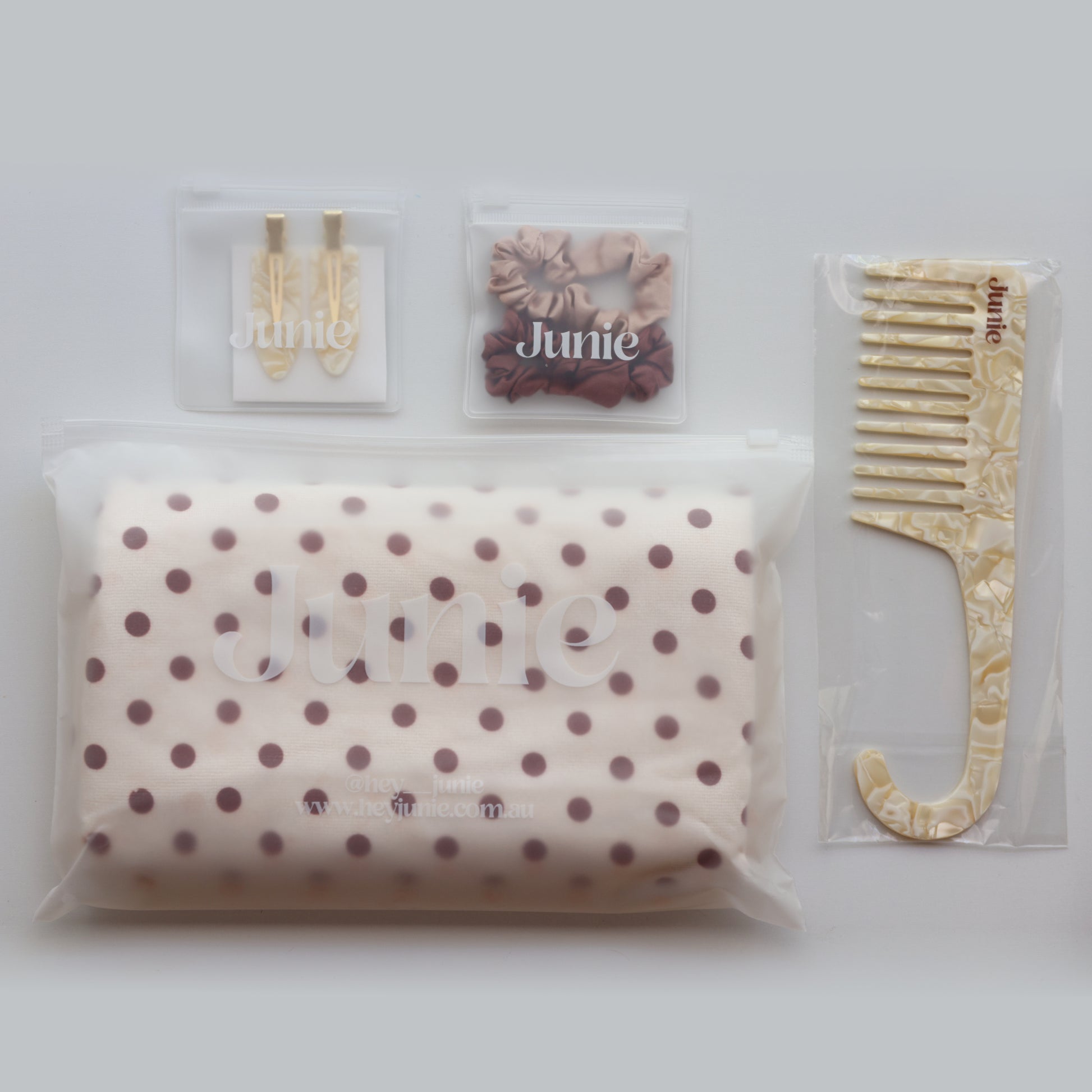 Junie hair care bundle in packaging, ready for gifting, including polka dot hair towel, silk scrunchies, crease-free clips, and wide tooth comb