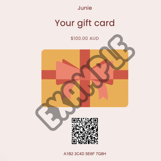 Junie gift card displayed in self-care setting, ideal for gifting
Gift card with a red bow design and QR code on a light pink background