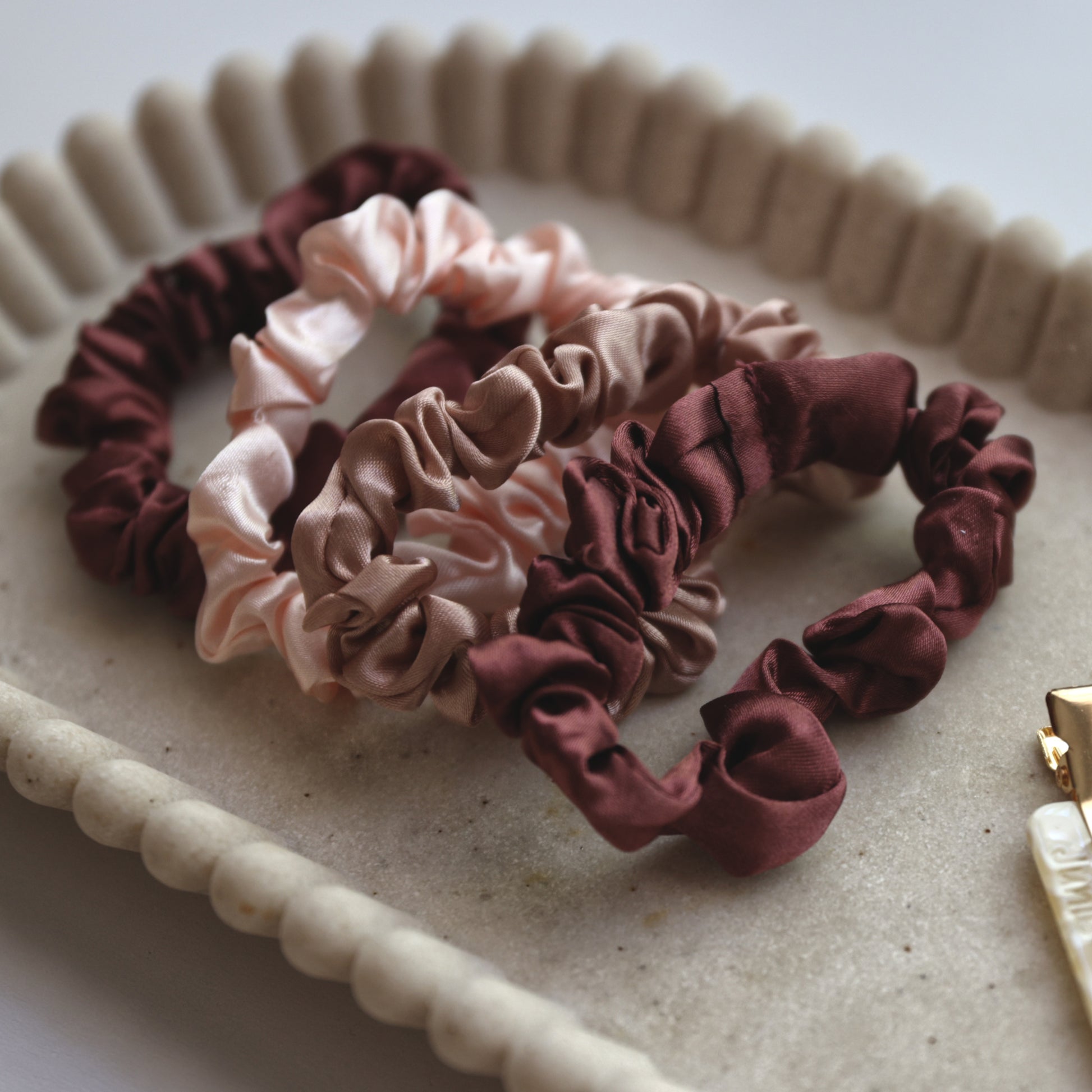 Junie hair scrunchies close-up showing soft fabric and smooth finish