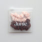 Set of pink and brown scrunchies in a clear packaging  zip lock bag with 'Junie' branding
Junie hair scrunchies in pastel colours, neatly packaged for gifting or storage