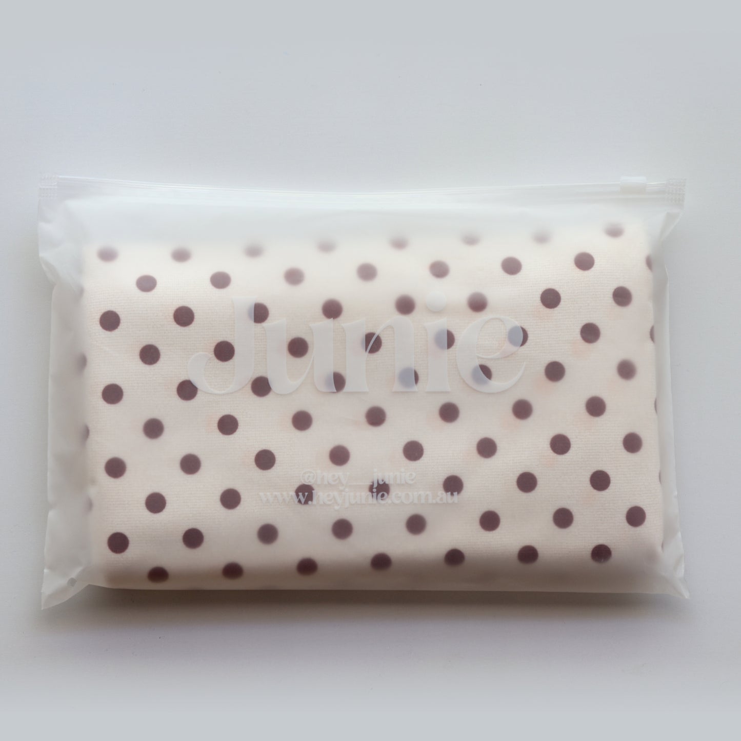 Junie fast-drying hair towel in blush pink, neatly packed inside reusable zip-lock wet bag