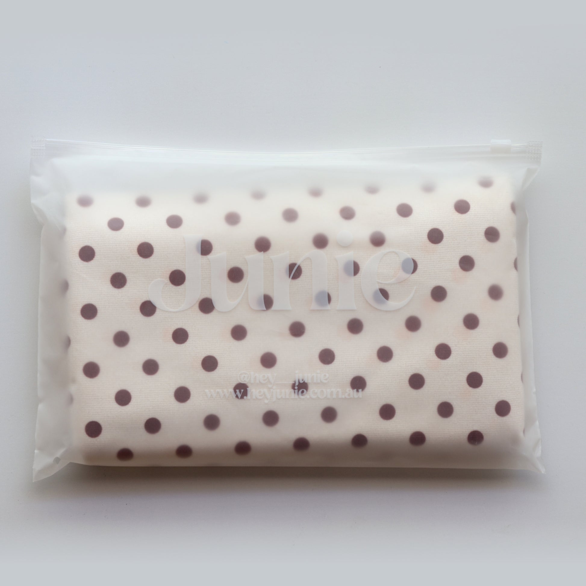 Junie fast-drying hair towel in blush pink, neatly packed inside reusable zip-lock wet bag