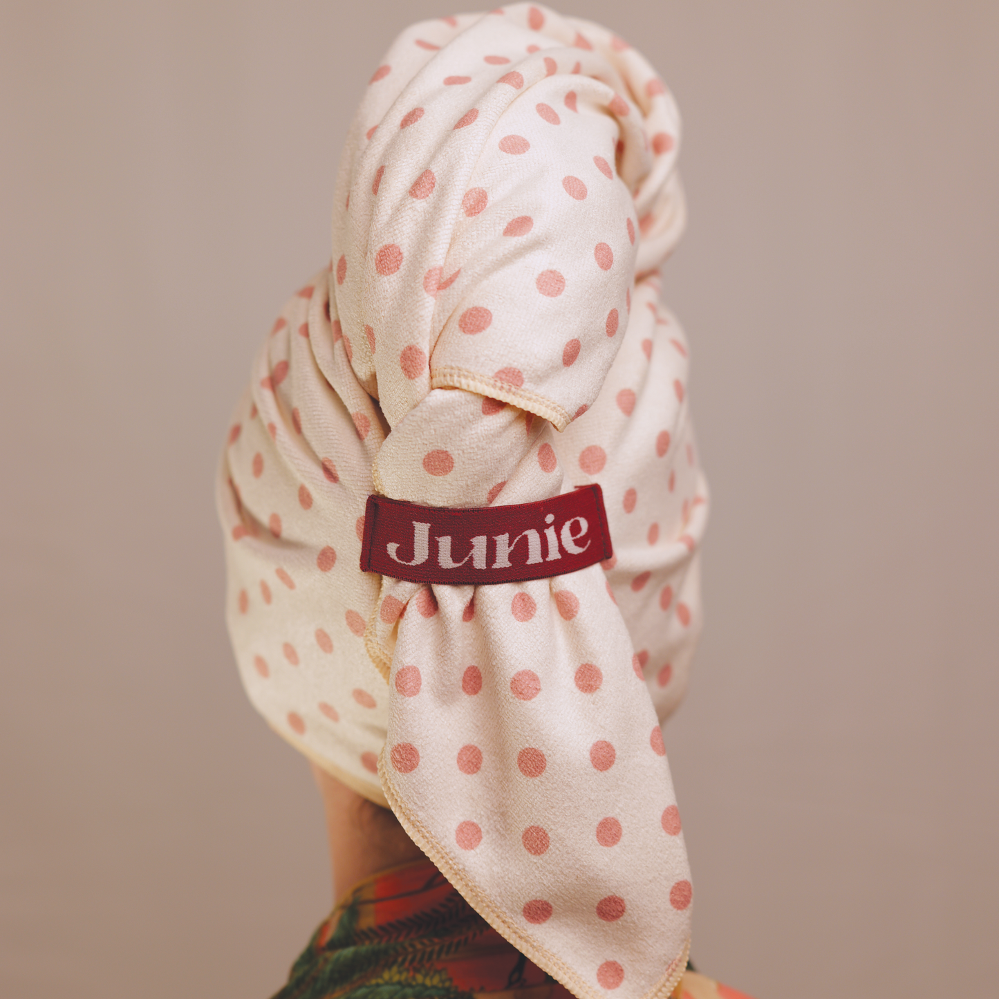 Junie fast-drying signature blend microfibre hair towel wrapped on wet hair, designed to absorb moisture quickly while reducing frizz, breakage and heat damage. Helps reduce heat styling and blow-drying time.