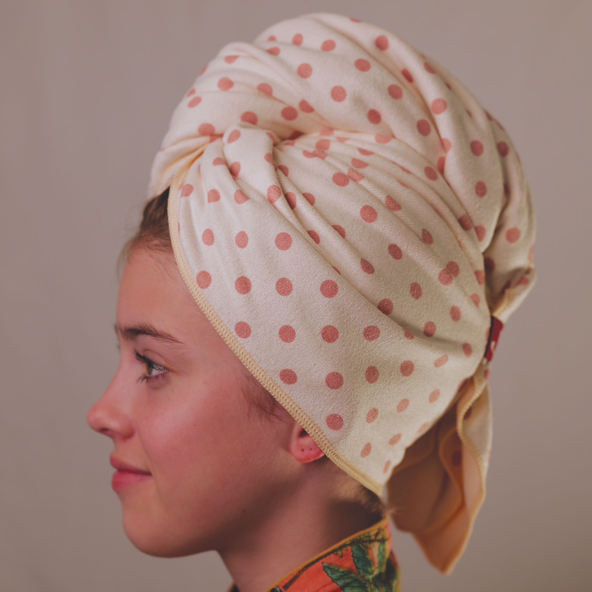 Side view of Junie quick-drying hair towel for curly hair prone to frizz and dryness, showing secure wrap design that stays in place while gently drying wet hair faster without friction.