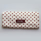 Junie fast-drying hair towel in blush pink with polka dots, neatly folded with the Junie elastic loop showing