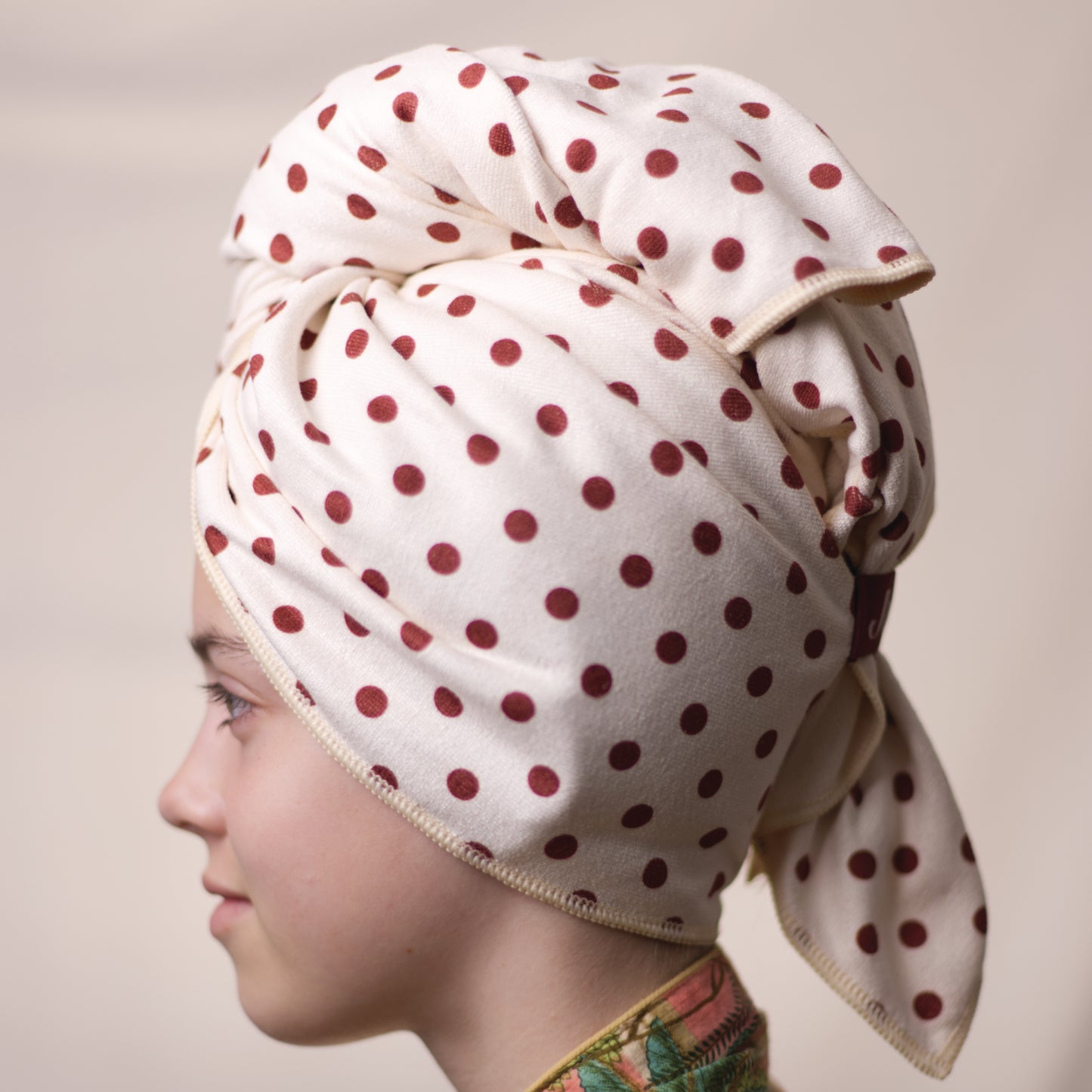 Side profile of Junie fast-drying hair towel for fine hair that needs gentle drying, featuring a secure wrap design that gently dries hair faster without friction or damage.