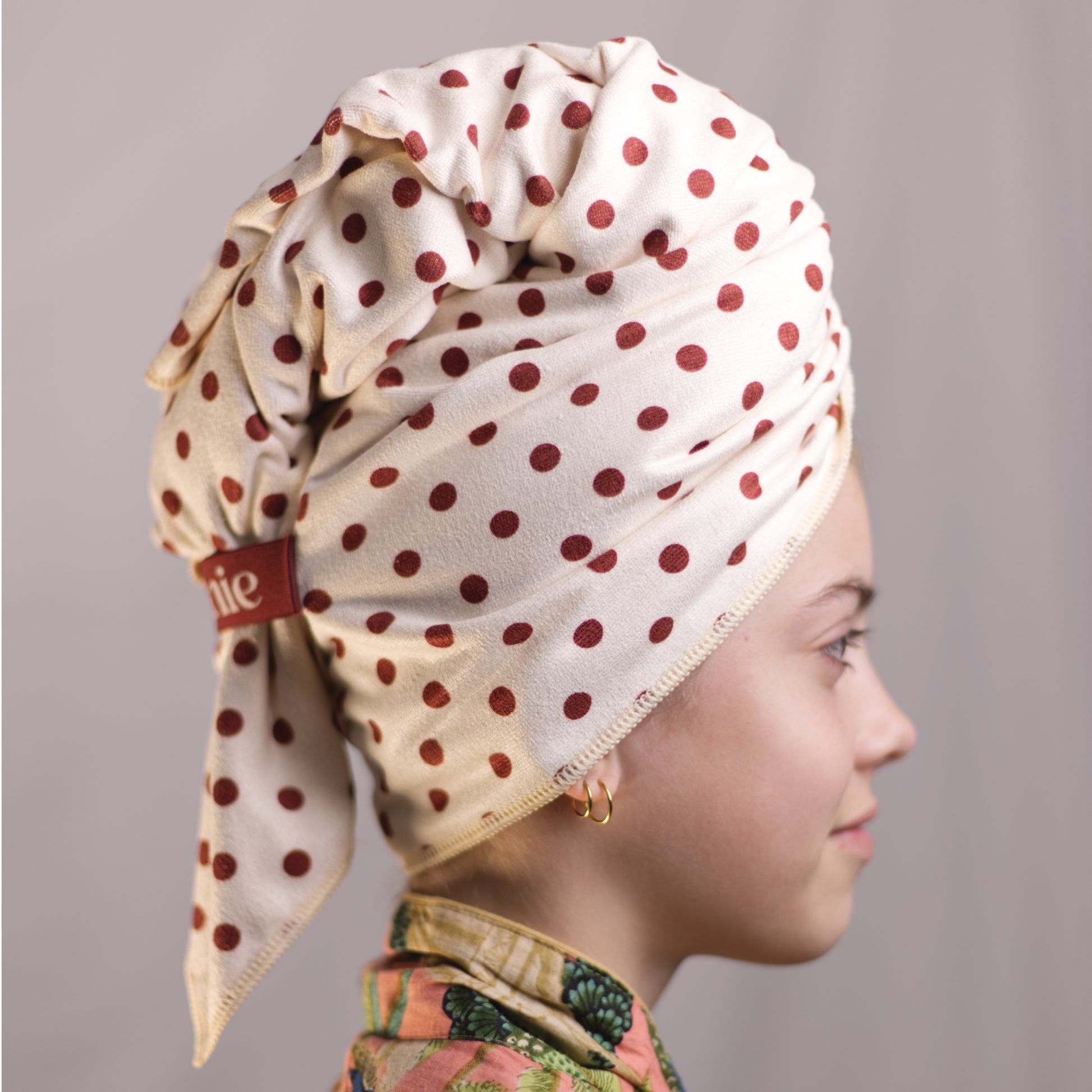 Side view of Junie fast-drying hair towel for curly hair prone to frizz and dryness, showing secure wrap design that stays in place while gently drying wet hair faster without friction.