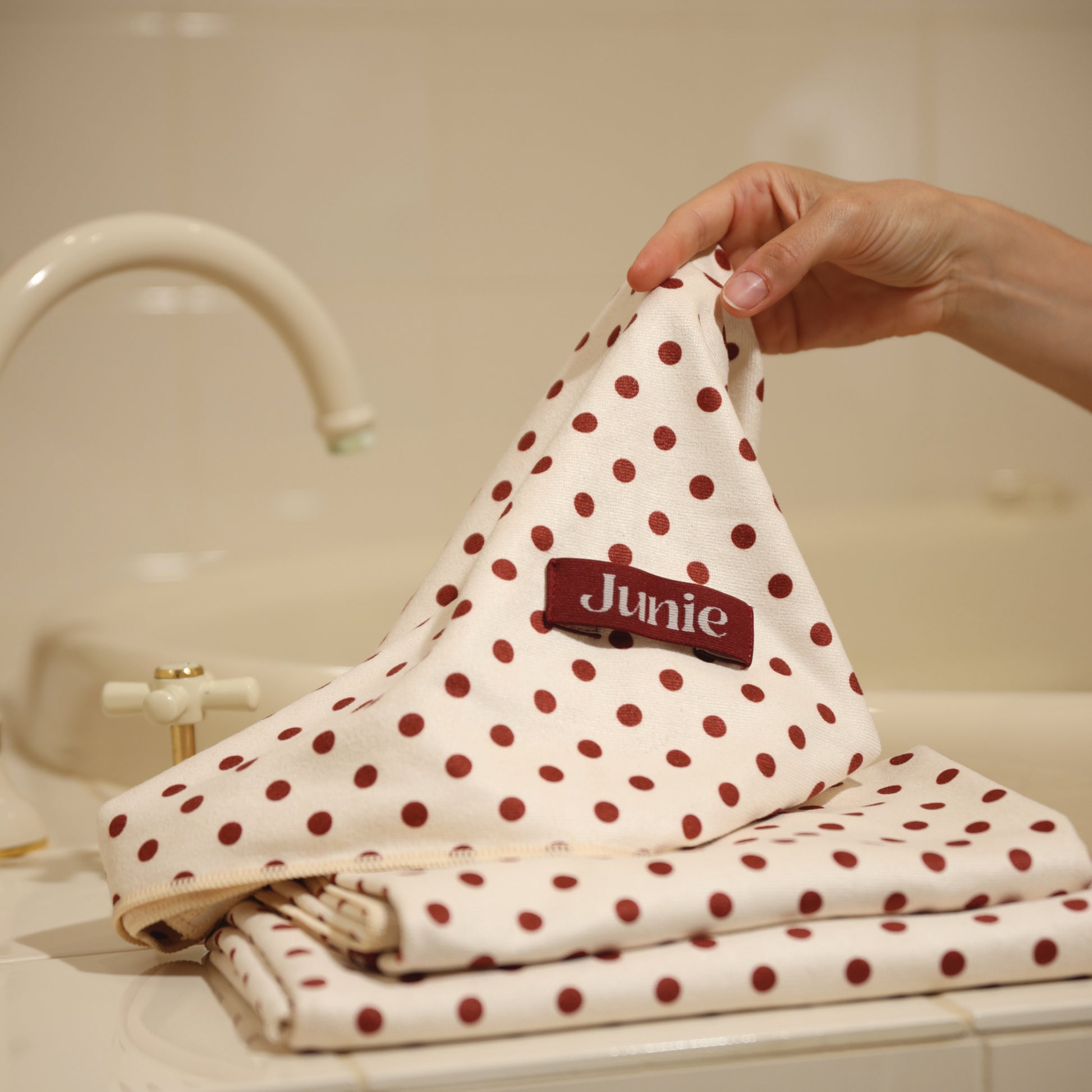 Junie fast-drying microfibre hair towel with polka dot design, lightweight and gentle on wet hair, designed to reduce frizz, breakage and drying time. Signature Junie fabric blend.

Junie fast-drying signature blend microfibre hair towel with lightweight, ultra-absorbent fabric that shortens drying time and protects delicate wet hair.