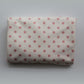 Folded Junie quick dry hair towel with peaches and cream polka dots on a white background