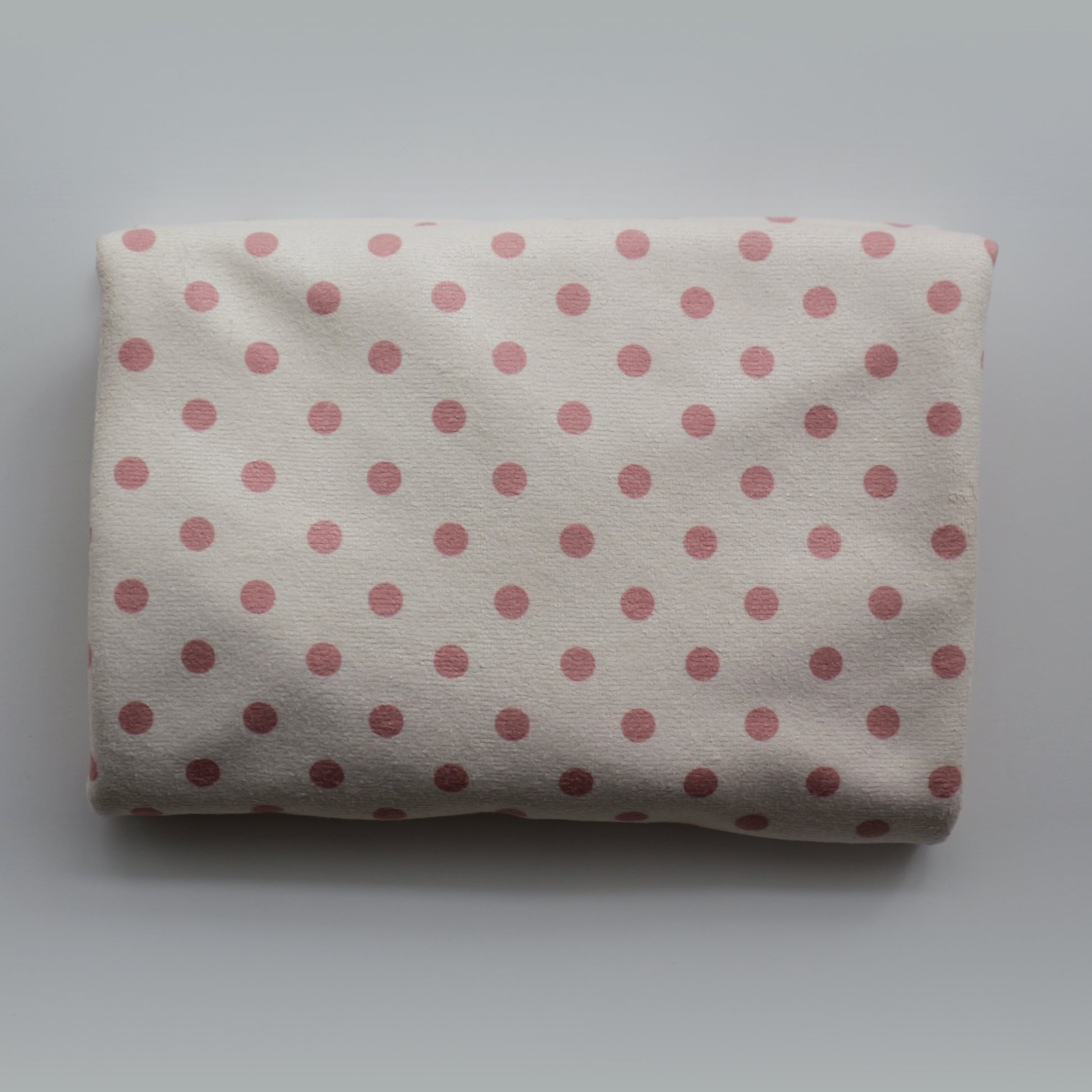 Folded Junie quick dry hair towel with peaches and cream polka dots on a white background
