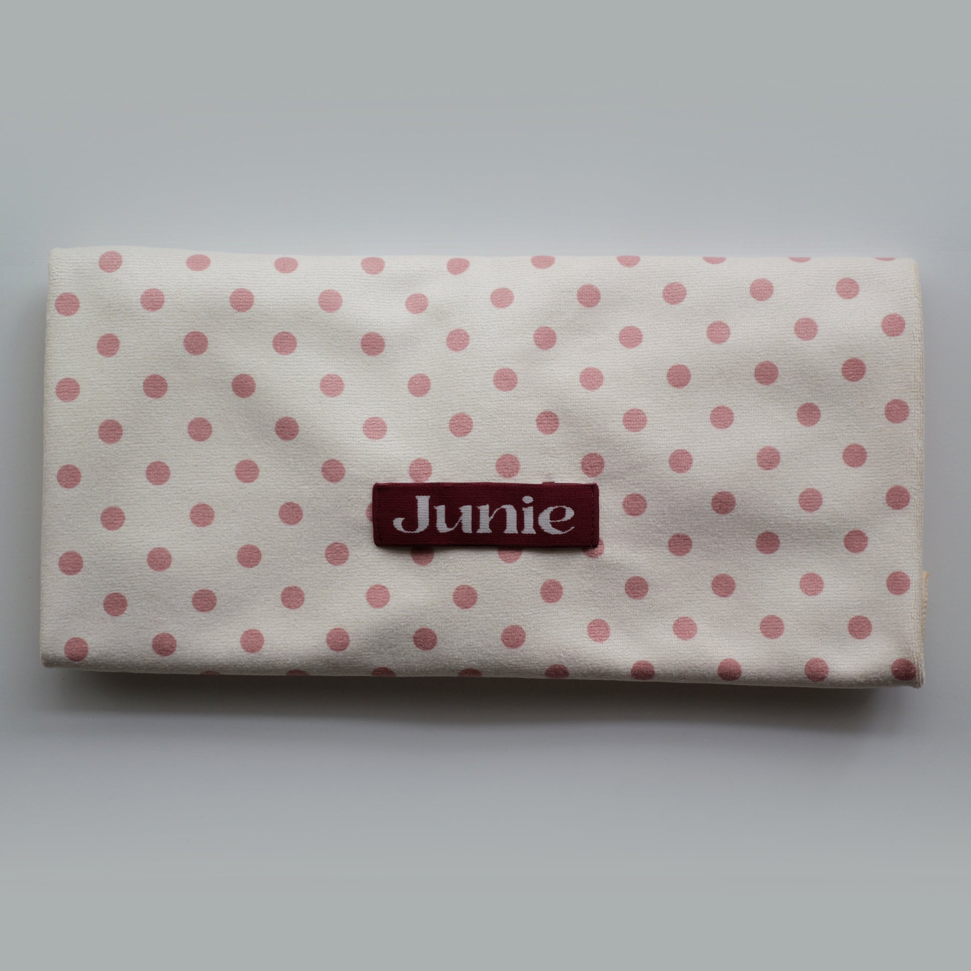 Polka dot Junie quick dry hair towel with peaches and cream print with 'Junie' label on a white background