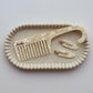 Junie wide-tooth comb and set of hair clips on a decorative tray with 'Junie' branding. Featuring soft natural light, perfect for hair care routine.
